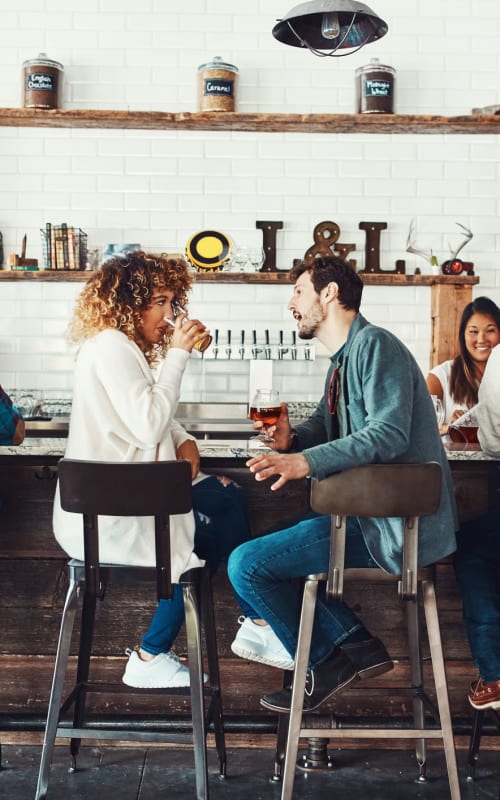 Friends grabbing drinks together at a cool spot near Mayfair Reserve in Wauwatosa, Wisconsin