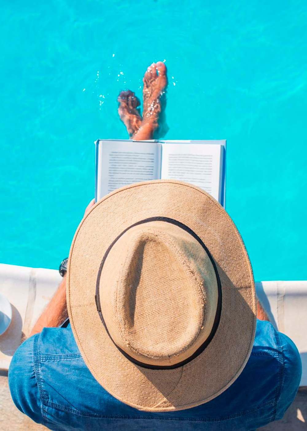 Resident reading by the pool at Terrene at the Grove in Wilsonville, Oregon 