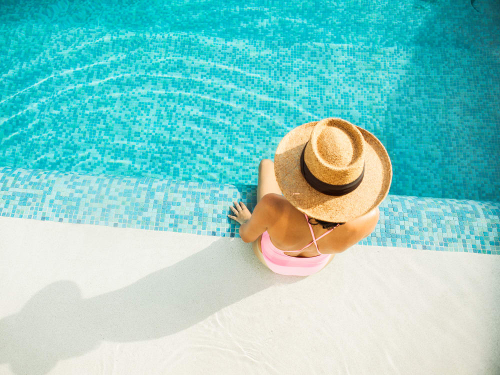 Resident relaxing poolside at Skyline Terrace Apartments in Burlingame, California