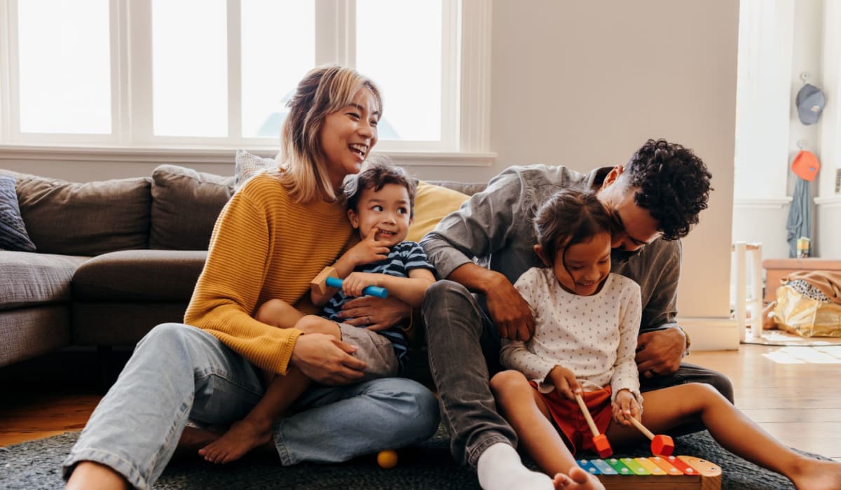 Family in their living room at Midtown Manor and Towers in Bryan, Texas