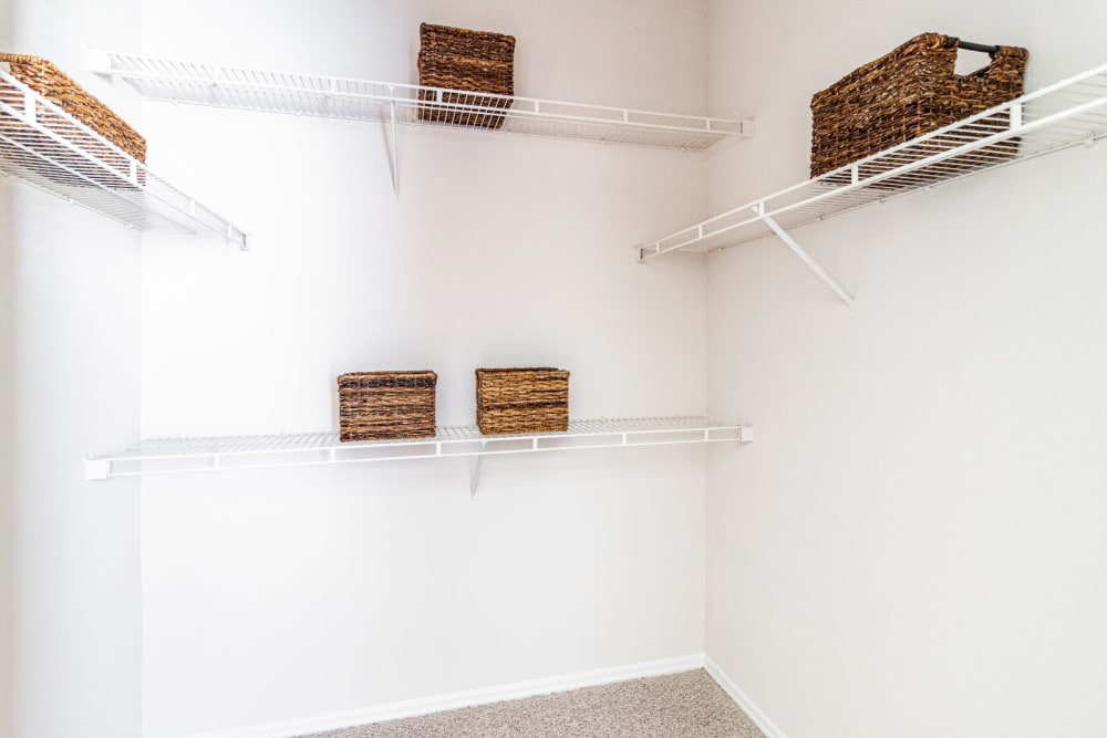 Walk in closet with built in organizer shelves at Marquis of Carmel Valley in Charlotte, North Carolina