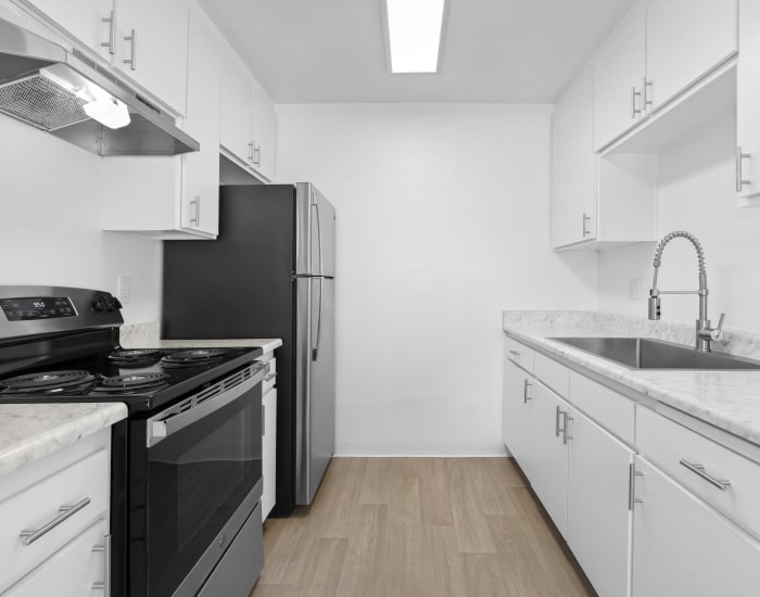 Spacious white kitchen with stainless-steel appliances at Vista Apartments in Chula Vista, California