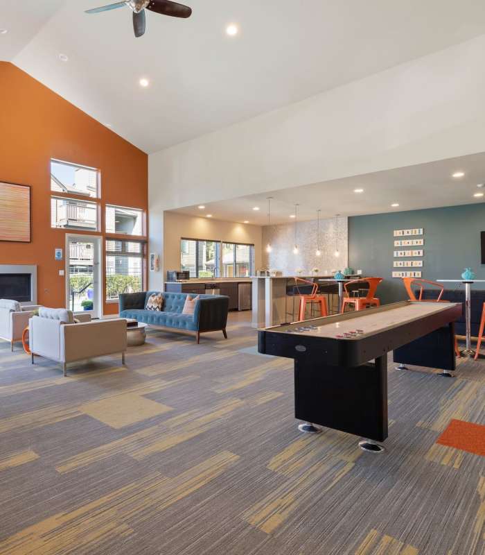 Clubhouse lounge area with games and seating at Foundry on Fifth in Renton, Washington