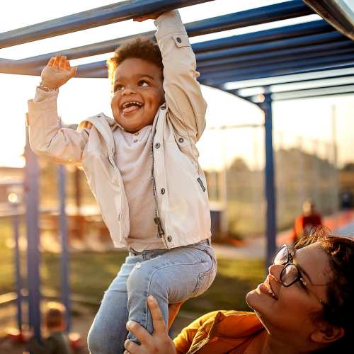 Resident kid playing with his mom in the playarea at Valley Park Subdivision in Jackson, Mississippi