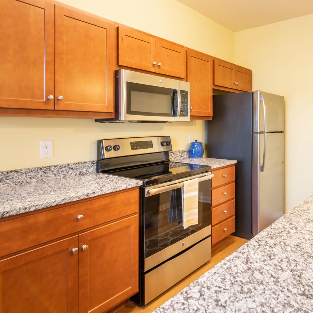 Stunning kitchen with nice wood cabinets and granite counter tops at The Reserve at White Oak in Garner, North Carolina