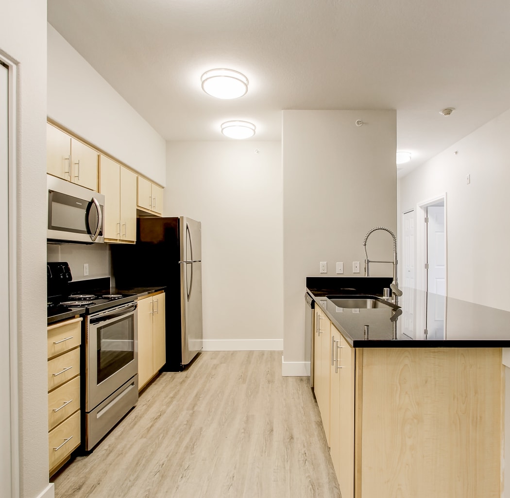 View of the kitchen and hallway at River Trail Apartments in Puyallup, Washington