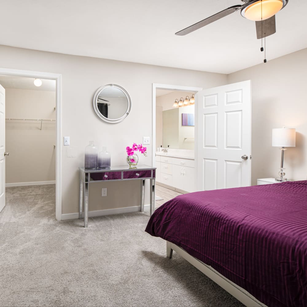 A bedroom with a walk-in closet and attached bathroom at Windsor Lake in Brandon, Mississippi