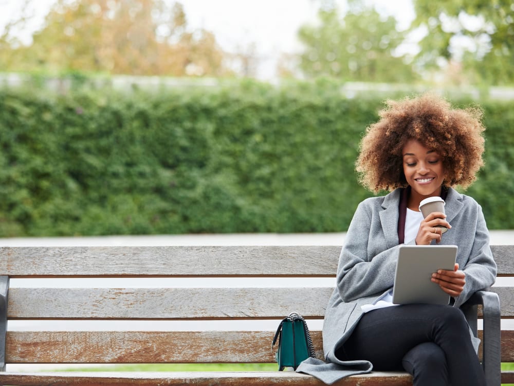 Resident reading her iPad in the park near Domus on the Boulevard in Mountain View, California