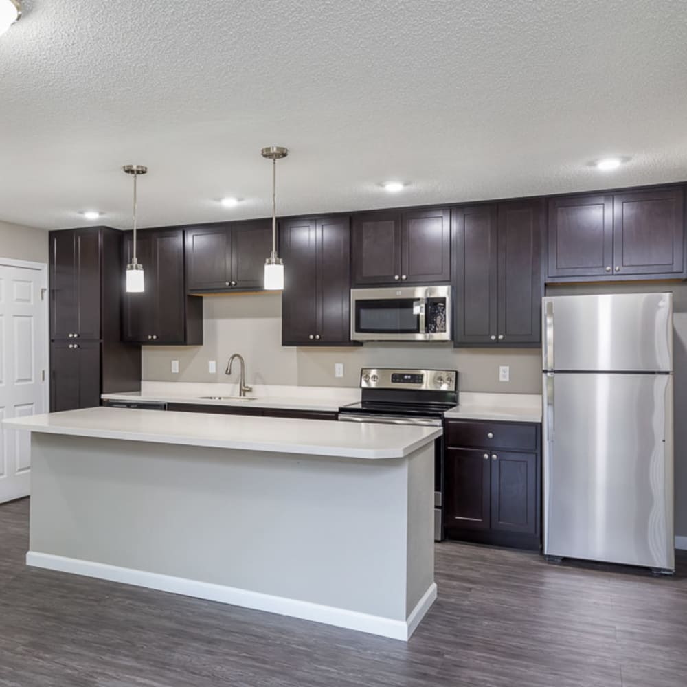 Updated kitchen with breakfast bar, modern appliances, and great lighting at Springhill Apartments in Overland Park, Kansas