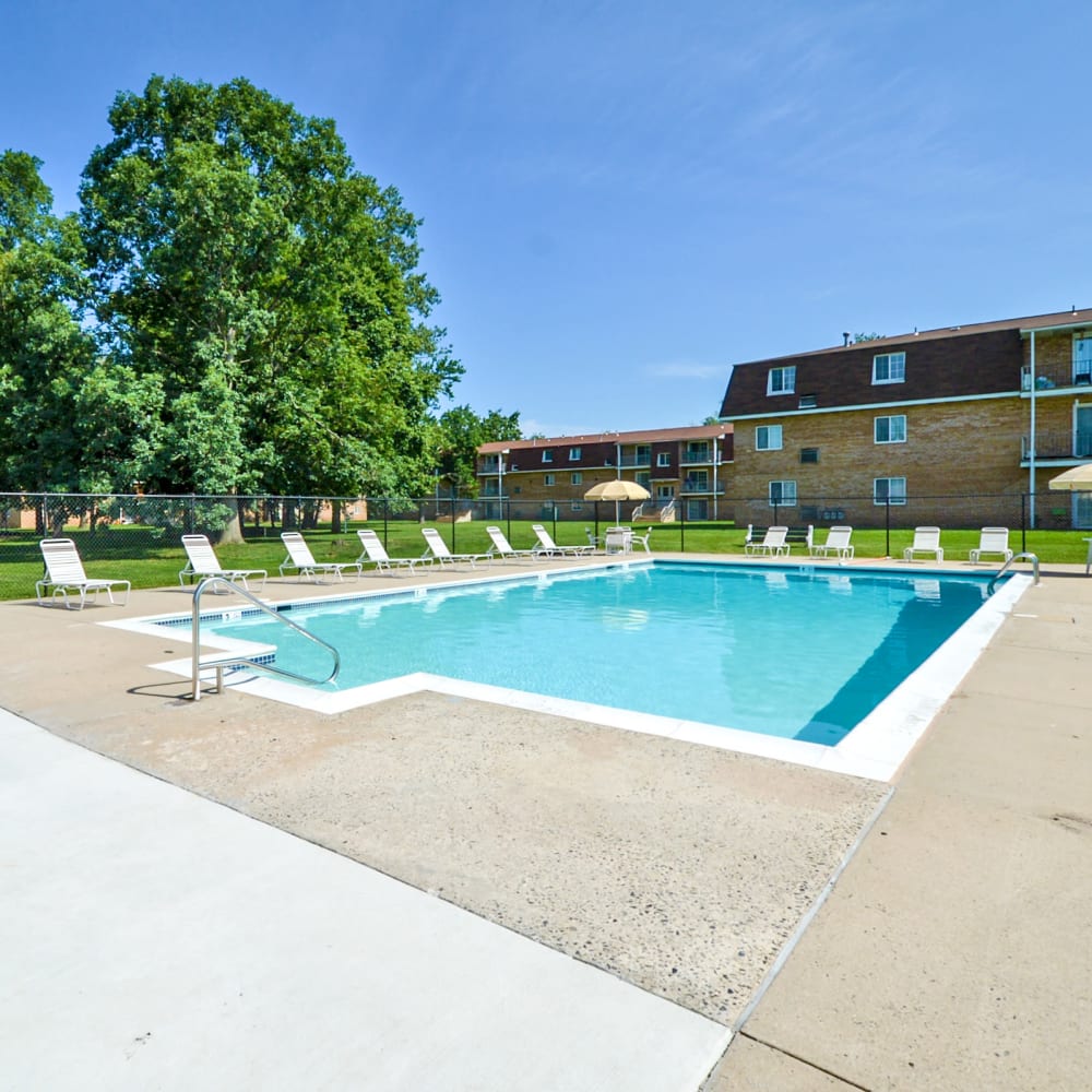 Swimming pool surrounded by lounge chairs at Main Street Apartment Homes in Lansdale, Pennsylvania