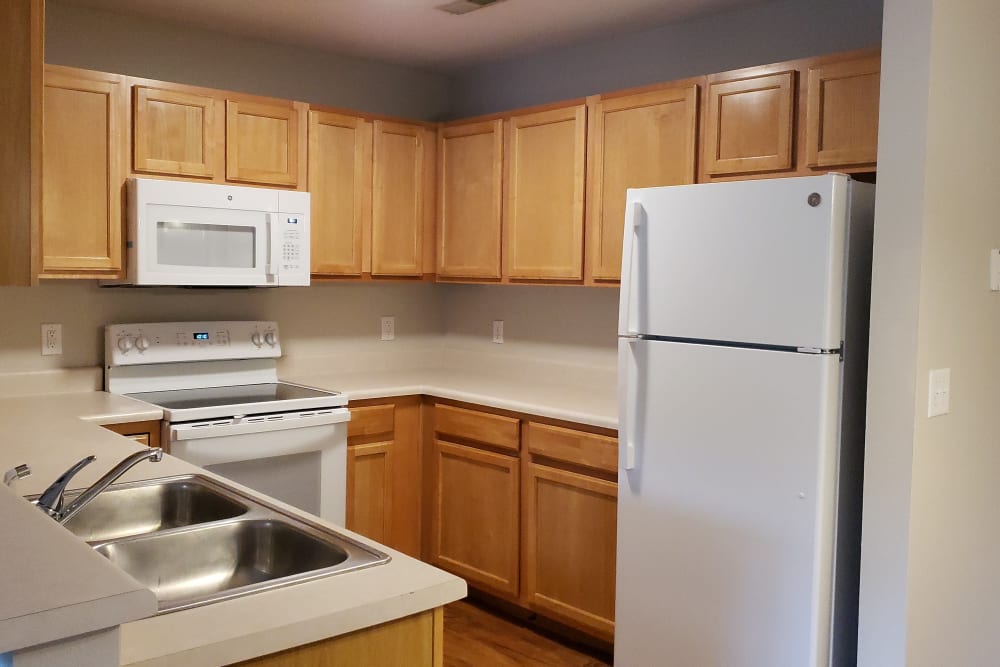 Model kitchen with large cupboards at Campbell Flats Apartments in Springfield, Missouri