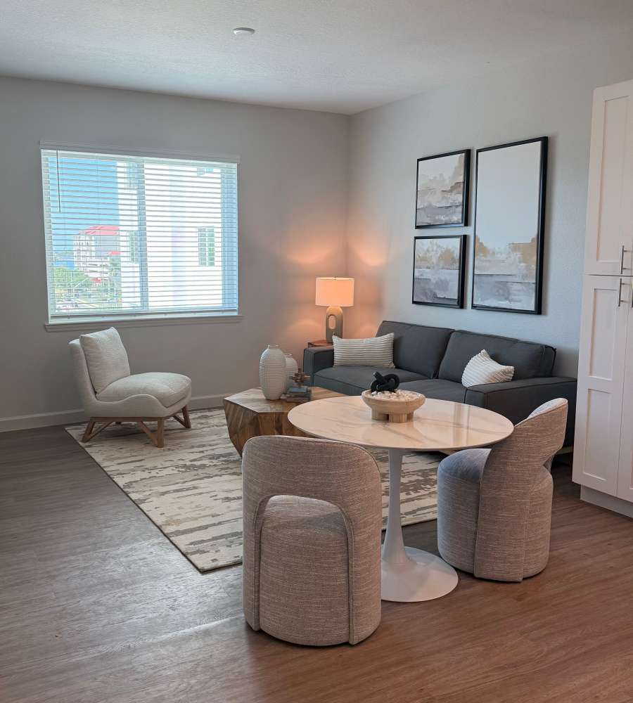 Resident setting the table prior to a meal in her home at Nine20 Manatee in Bradenton, Florida