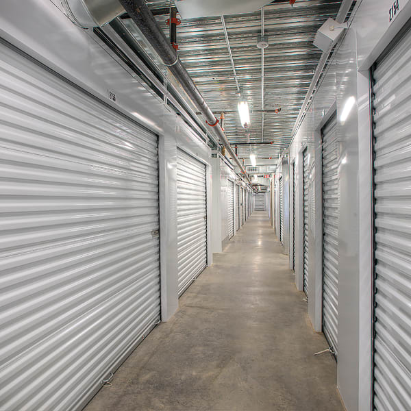 Indoor storage units with bright doors at StorQuest Self Storage in Van Nuys, California