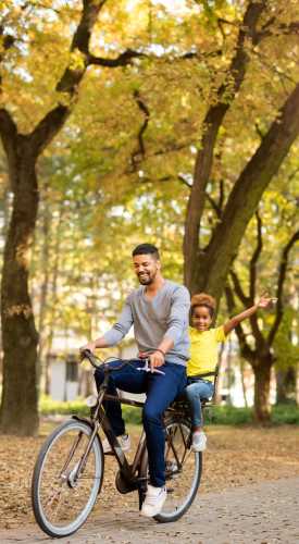 Father and son cycling at a park near One Belmar Place in Lakewood,Colorado