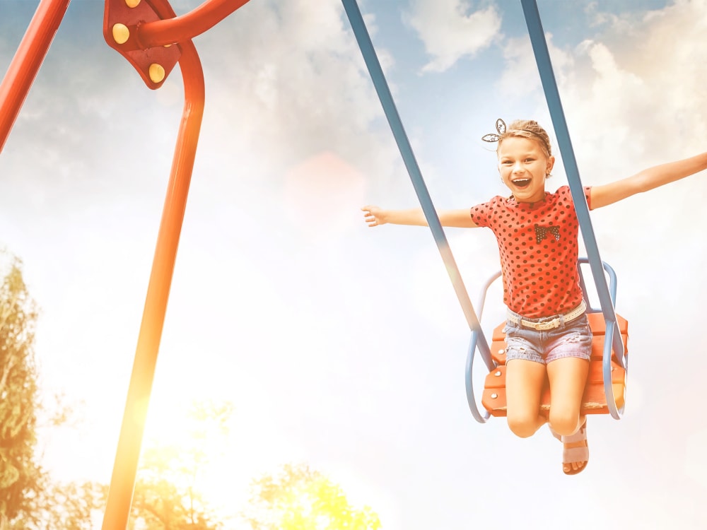 Kid on a swing at TerraLane on Cotton in Surprise, Arizona