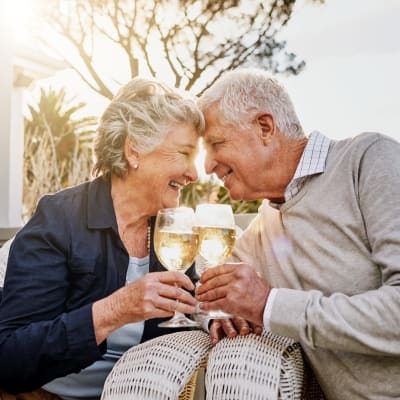 A resident couple toast to a fantastic day at at First & Main of Auburn Hills in Auburn Hills, Michigan