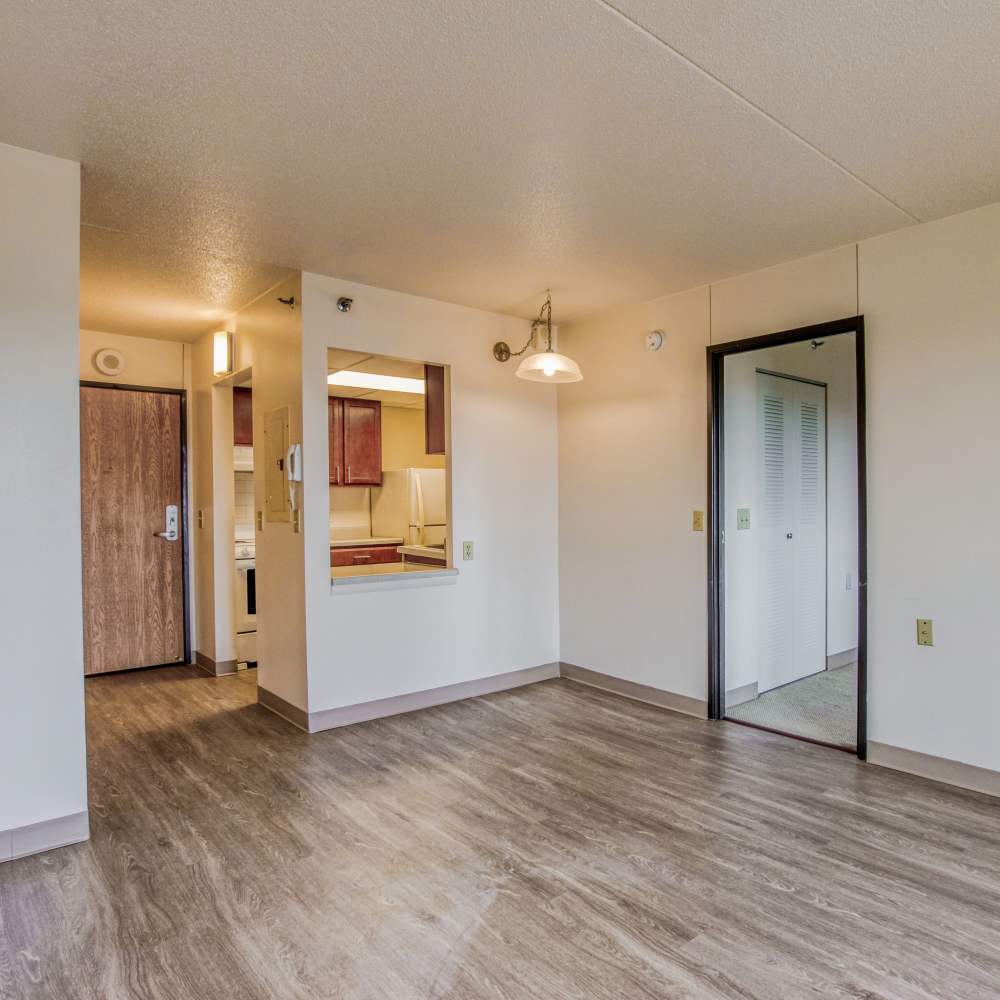 Living room with wood flooring at Village Center in Detroit, Michigan