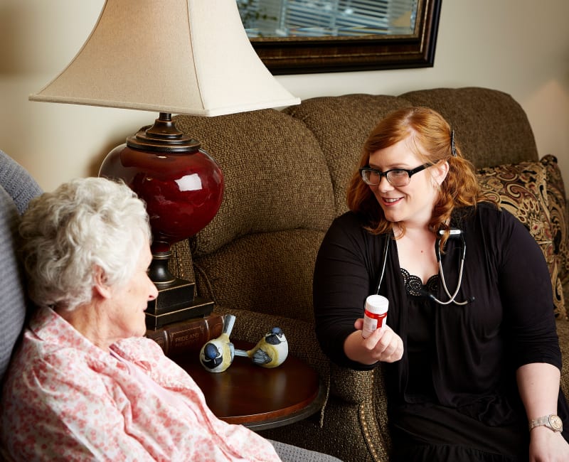 Residents and staff talking about medication at Deer Crest Senior Living in Red Wing, Minnesota