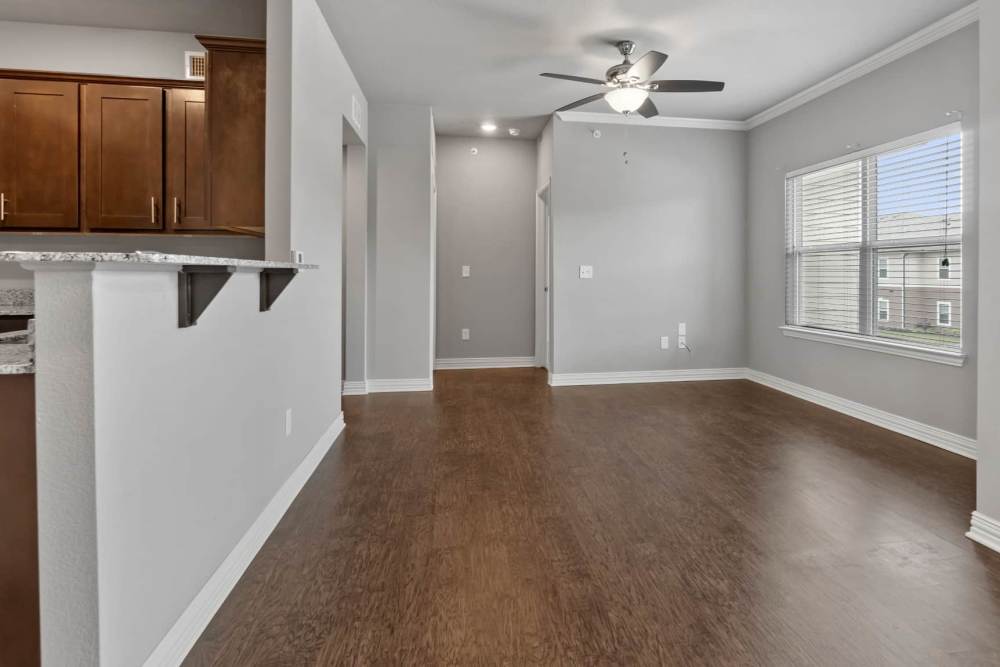 Well-lit apartment living area at Pine Creek in Paris, Texas
