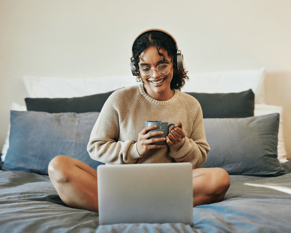 Resident workin on her laptop in her bedroom at The Millton in Redwood City, California