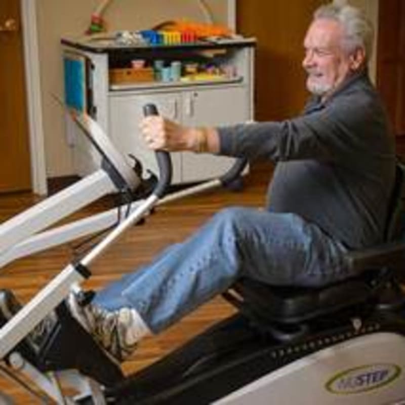 Senior man using an exercise machine at Peninsula Reflections in Colma, California