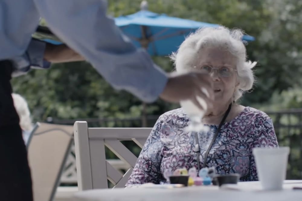 Resident being waited on at a Anthology Senior Living community