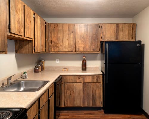 Kitchen with stylish black appliances at Westpointe Apartments in Pittsburgh, Pennsylvania