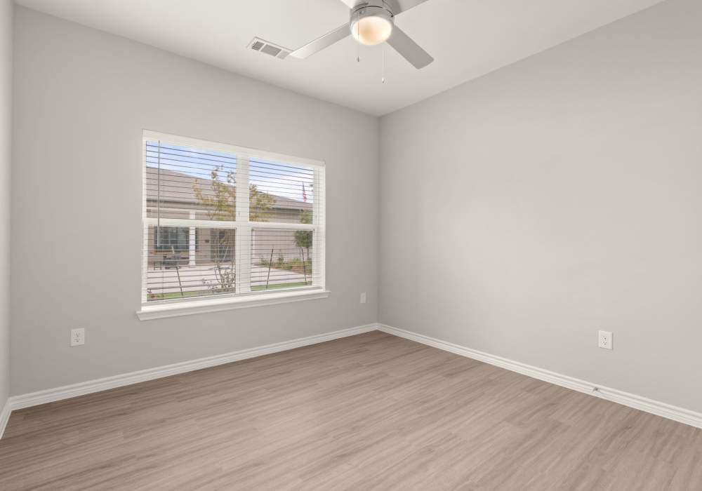 Unfurnished bedroom with wood-style flooring at Walnut Springs in Seguin, Texas