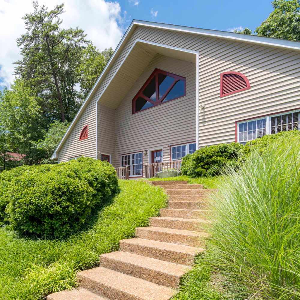 A view of the apartment home with stairs leading to the entrance at Park Canyon in Dalton, Georgia