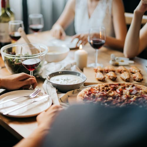 Resident having a meal and glass of wine with friends at a local restaurant near Westover Pointe in Wilmington, Delaware