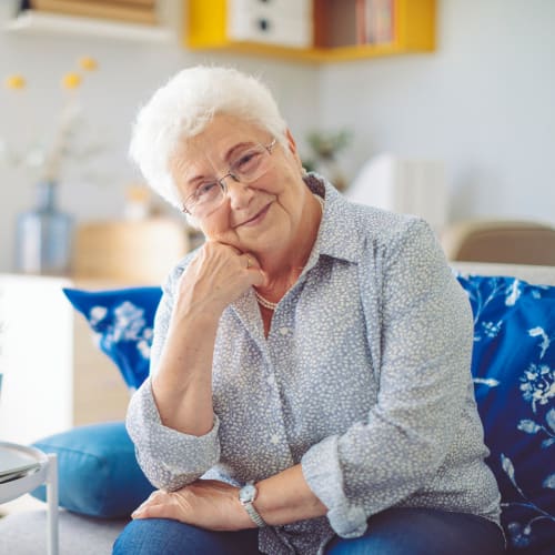 Resident relaxing in her apartment at Oxford Vista Wichita in Wichita, Kansas