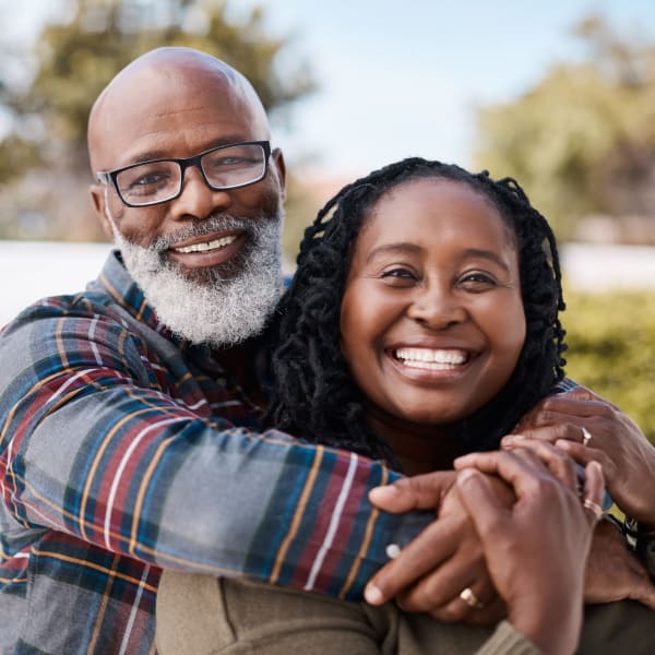 Couple smiling and posing at Pacifica Senior Living Encinitas in Encinitas, California.