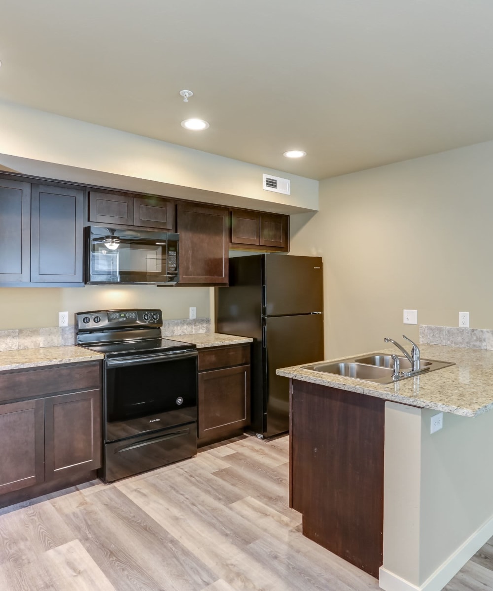 Model kitchen with island at Cedar Park & Canyon Falls Townhomes in Twin Falls, Idaho