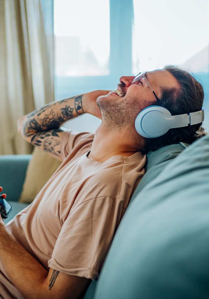 Resident listening to music in a modern home at Dunbar Apartments in Lexington, North Carolina