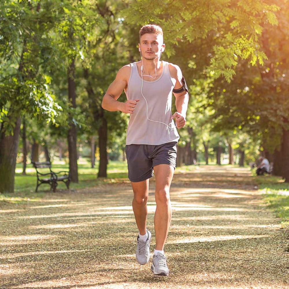 Resident going for a morning jog through the city near Oaks 5th Street Crossing At City Center in Garland, Texas