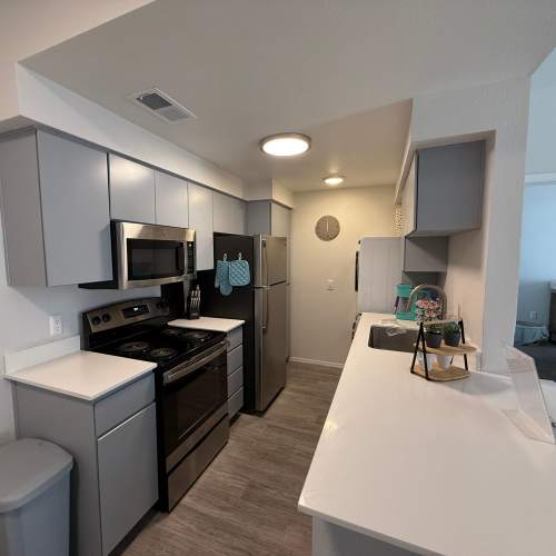 Quartz countertops and stainless-steel appliances in the model kitchen at Tierra Vida in Tucson, Arizona