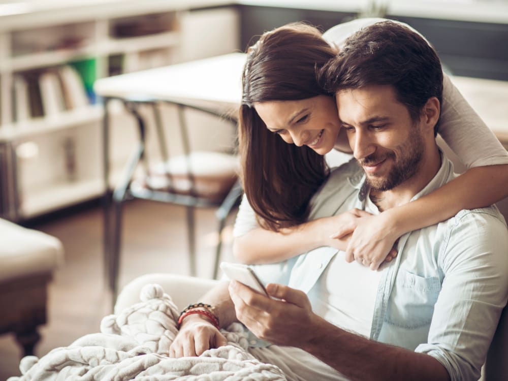 Residents relaxing and surfing the web on a mobile device in their new home at Sofi Lakeside in Everett, Washington