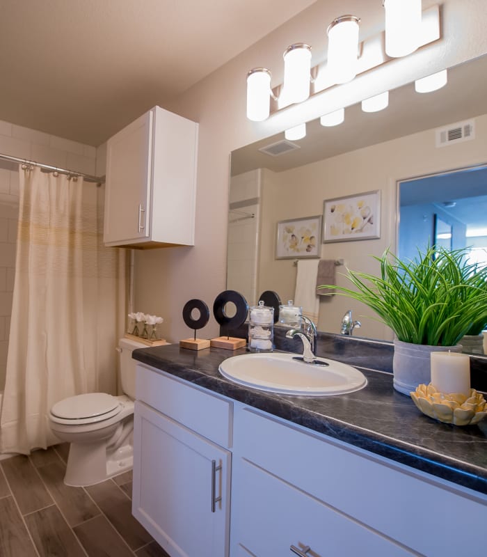 Bathroom with tile flooring at Cottages at Tallgrass Point Apartments in Owasso, Oklahoma