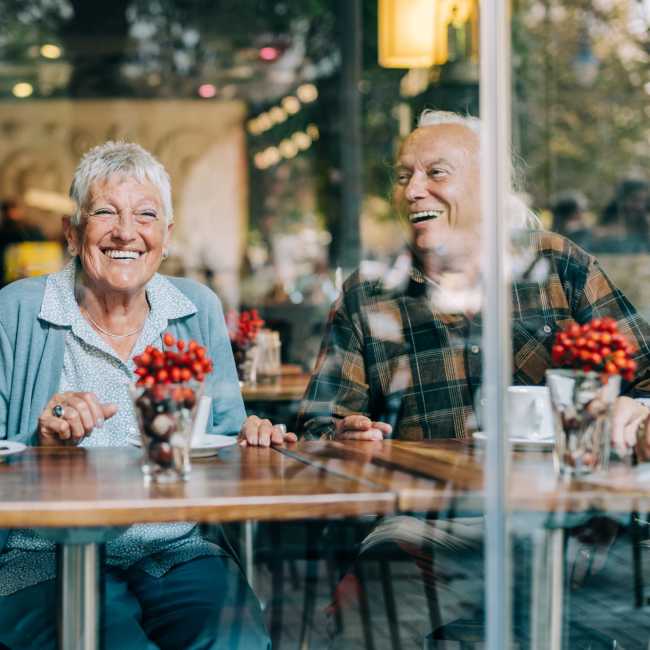 Resident friends sharing a laugh at their favorite restaurant near Heirloom at Torrey Pines in Las Vegas, Nevada