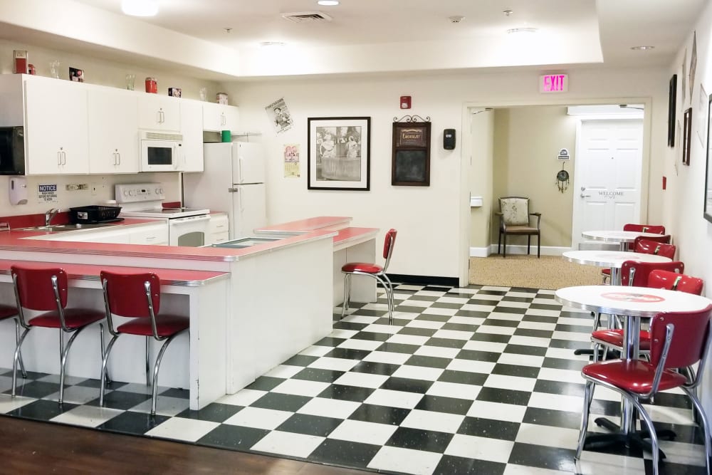 Dining room with black and white tile floor at Meadowlark Senior Living in Lebanon, Oregon.
