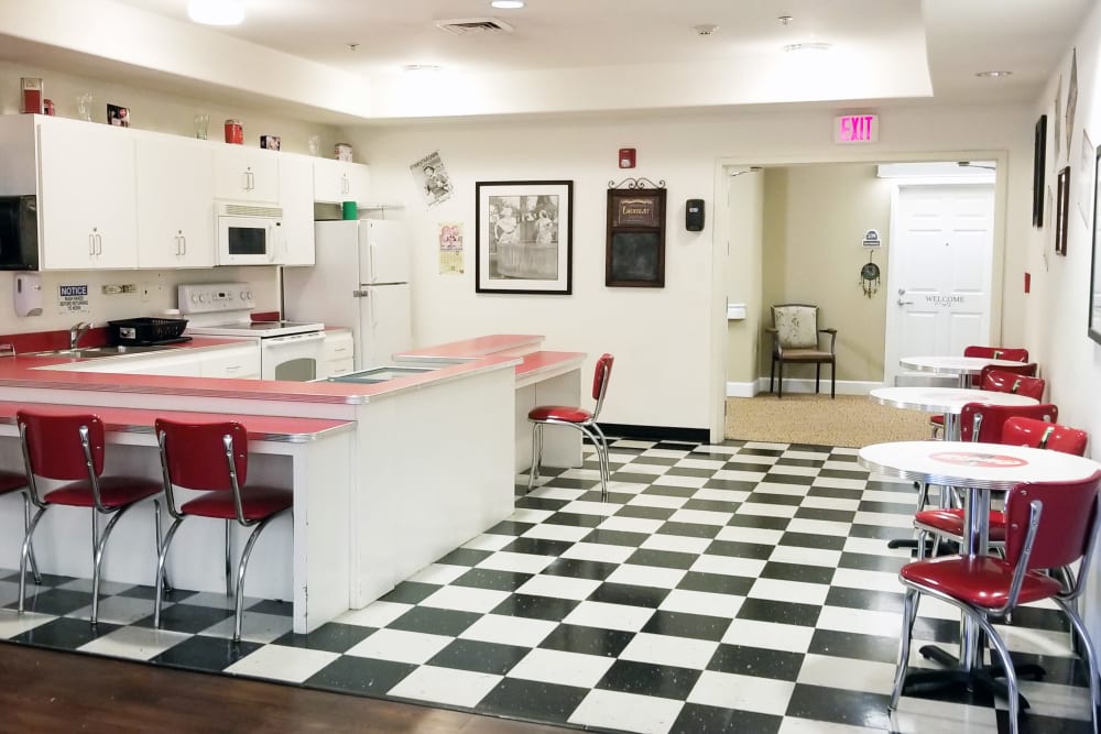 Dining room with black and white tile floor at Meadowlark Senior Living in Lebanon, Oregon. 