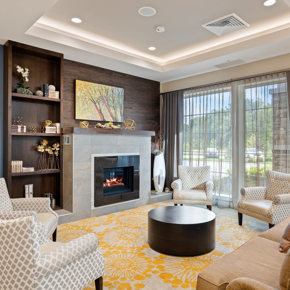 Elegant sitting room with fireplace at Anthology of Overland Park in Overland Park, Kansas