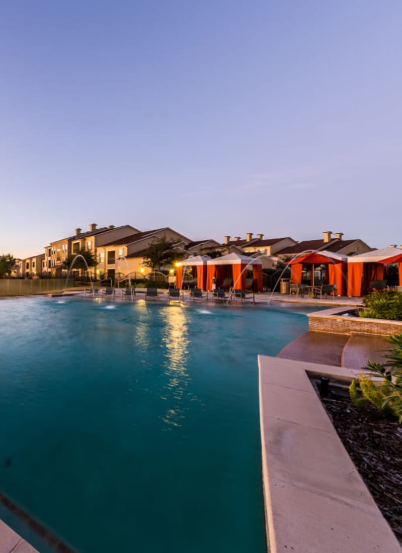 Sparkling pool with water features and gazebos at Marquis at the Reserve in Katy, Texas