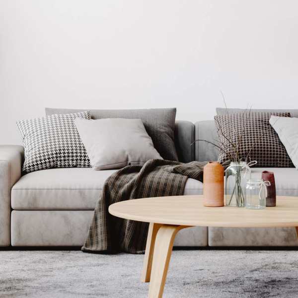 A bright living room, a comfy couch with coffee table and hanging lamp at Park Manor in Lebanon, Oregon