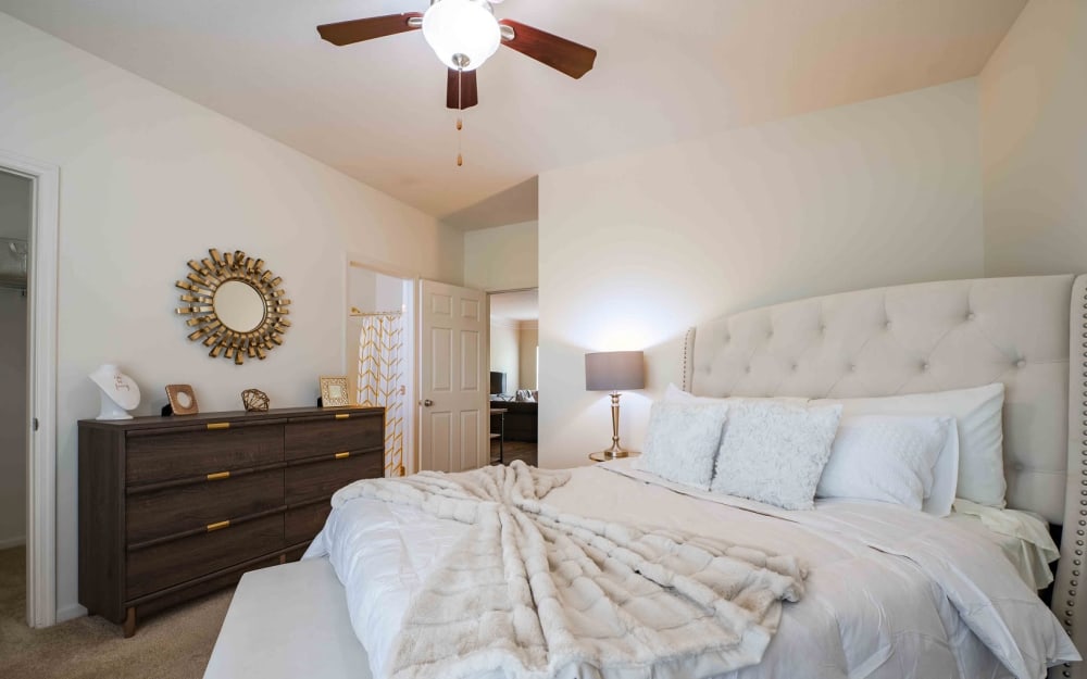 Model bedroom with ensuite bathroom and walk-in closet at Easton Commons Apartments & Townhomes in Columbus, Ohio