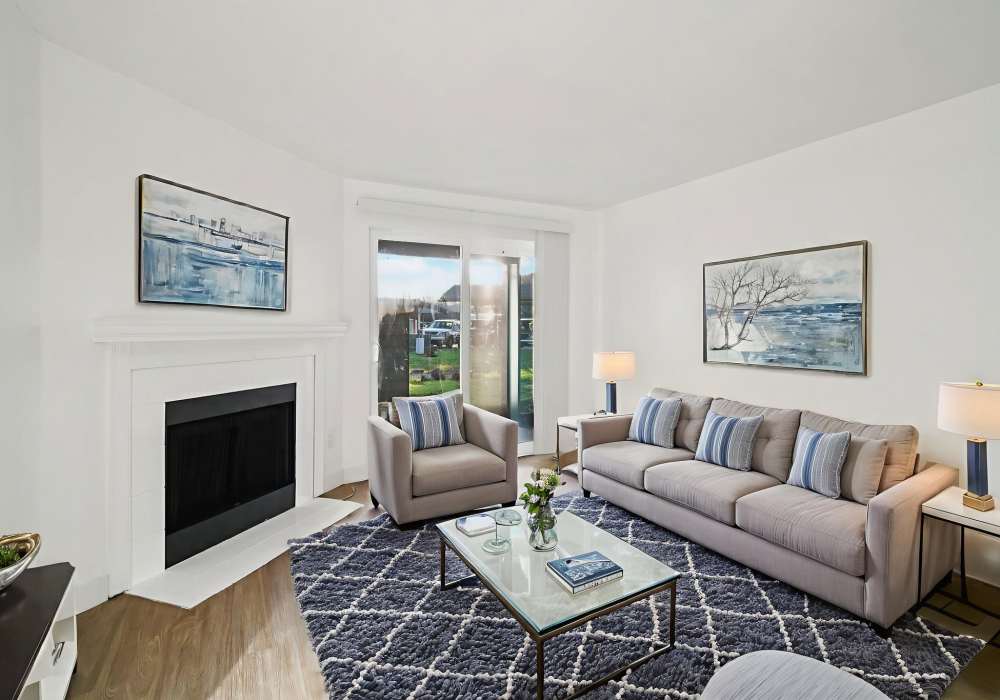 Living room with virtually staged furniture and fireplace at Foundry on Fifth in Renton, Washington