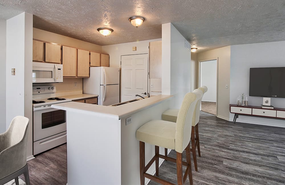 Fully-equipped kitchen with a breakfast bar at Westview Commons Apartments in Rochester, New York
