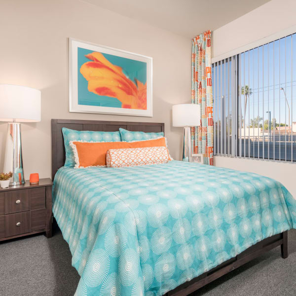Well-decorated master bedroom with a ceiling fan in a model home at Tempe Metro in Tempe, Arizona