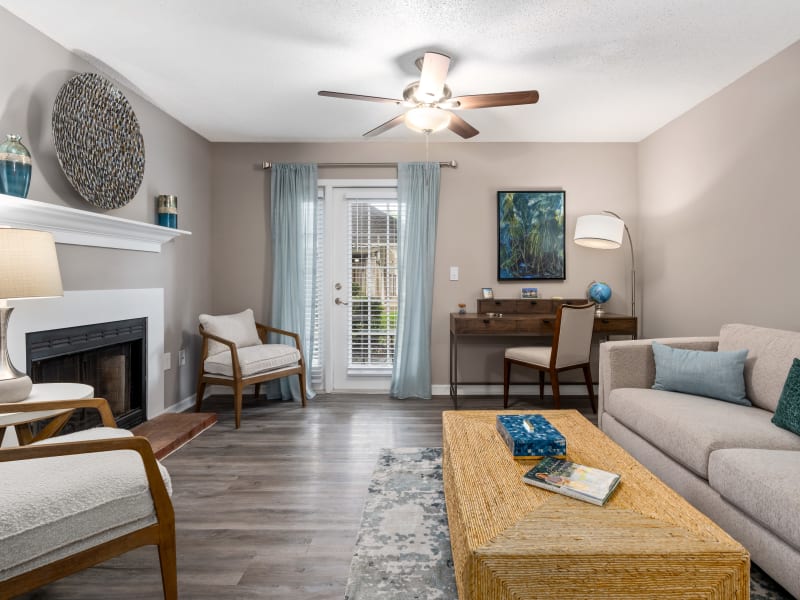 Hardwood flooring and a fireplace in a model apartment at Arbor Gates in Fairhope, Alabama