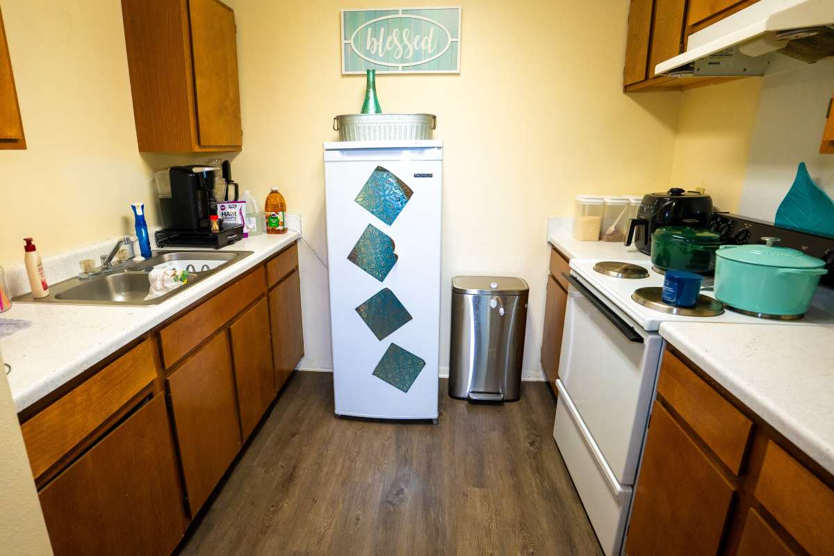 Cozy kitchen with wood-style flooring, stainless steel appliances, and ample cabinet space at Willowbrook I in Lafayette, Louisiana